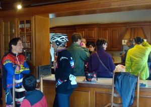 Steve Cochrane (at left in blue and red jersey) chats to Princeton neighbors over hot cider in Mountain Lakes House. (click to expand.)