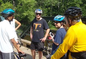 Princeton Mayor Liz Lempert (center, holding cell phone) consults with local transportation officials  while checking out a new cycle route in Princeton earlier this year. (Click to expand.)