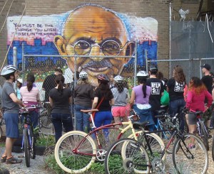 Riders inspect a mural of Mahatma Ghandi during the Trenton Social Ride. 'Ghandi Garden' is a project of the S.A.G.E. coalition, who are planning a mural at Princeton's Paul Robeson Center. (click to expand).