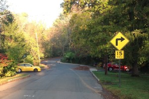 Existing Belgian block curb and sidewalk on Poe Road beyond Random Road. (click to expand.)